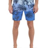 Blue leaf-patterned swim shorts worn by a person on a white background