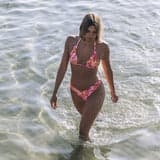 Woman in a pink bikini walking in shallow water