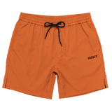 Orange shorts with a black drawstring and 'Hurley' logo on a white background
