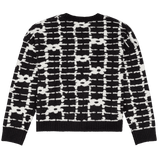 Black and white patterned sweater on a white background