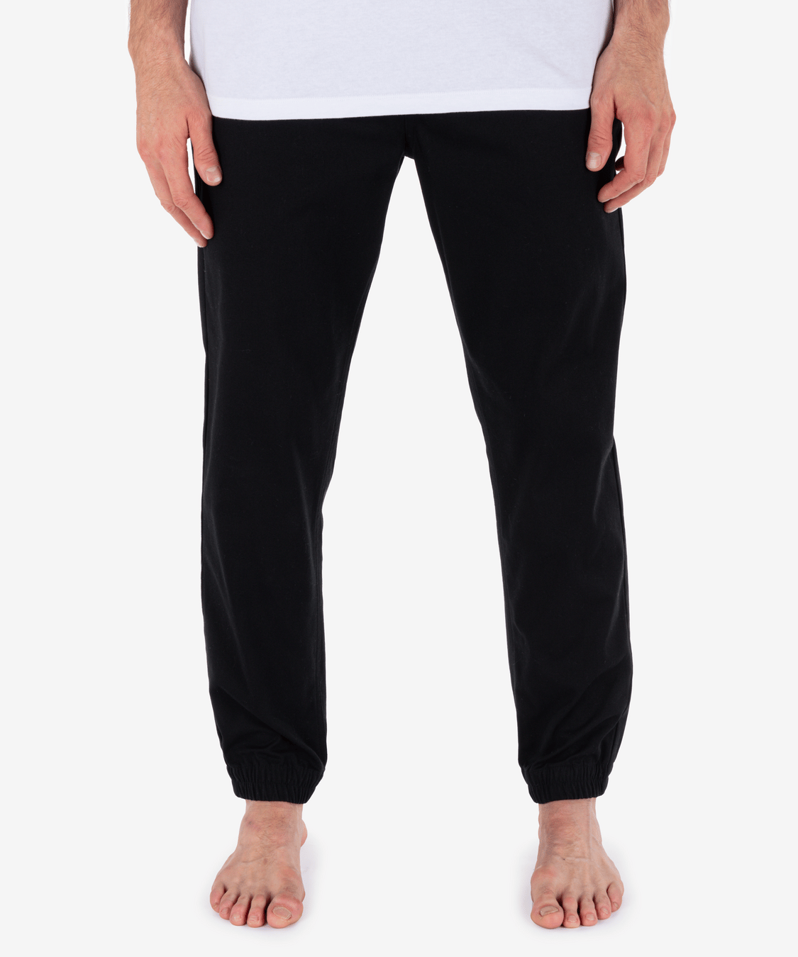 Black pants worn by a person on a white background