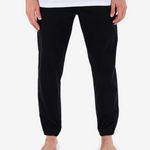 Black pants worn by a person on a white background