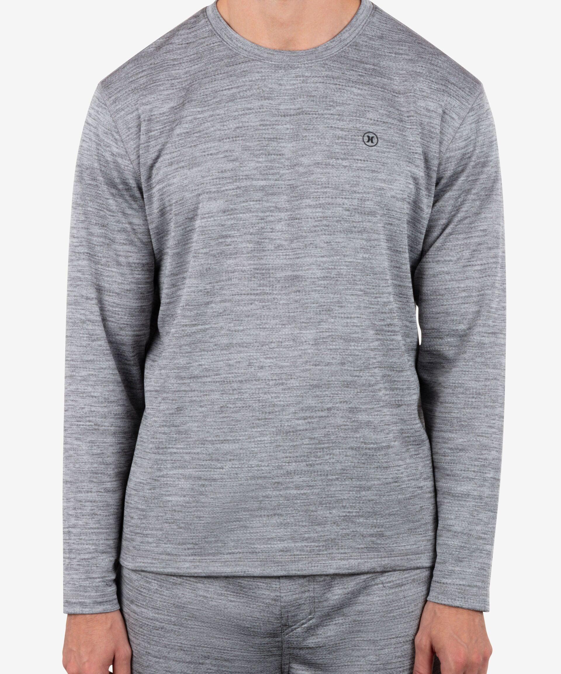Person wearing a gray long-sleeve shirt and pants on a white background